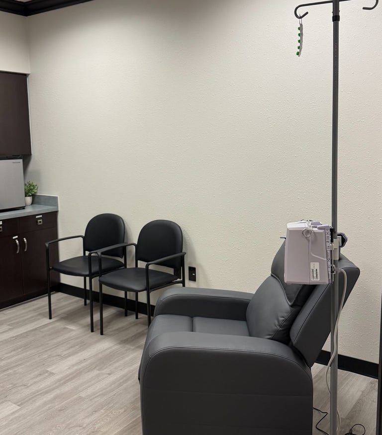 Infusion treatment room with a reclining chair and IV setup for neurological therapies and migraine infusions.