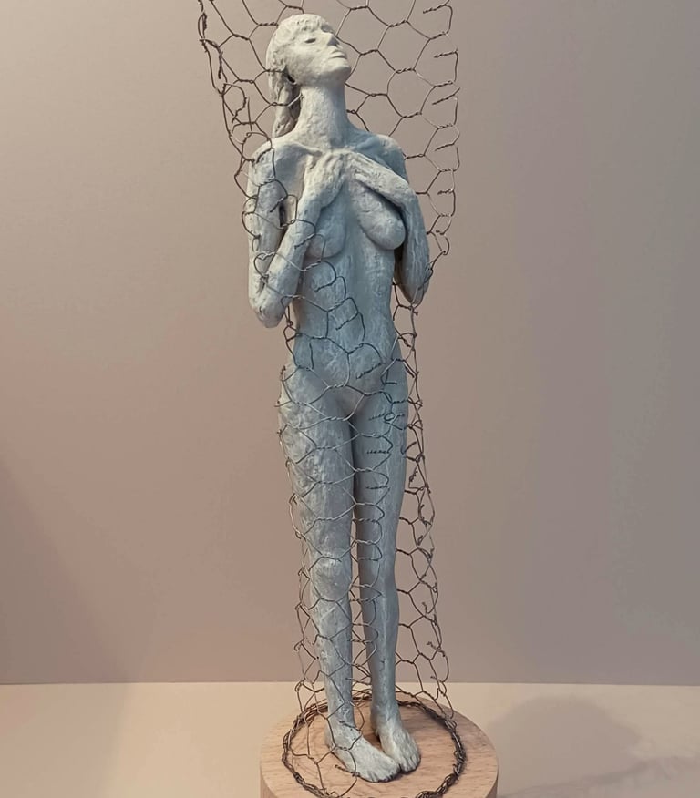 A standing female figure, leaning back with eyes closed, surrounded by a wire netting enclosure