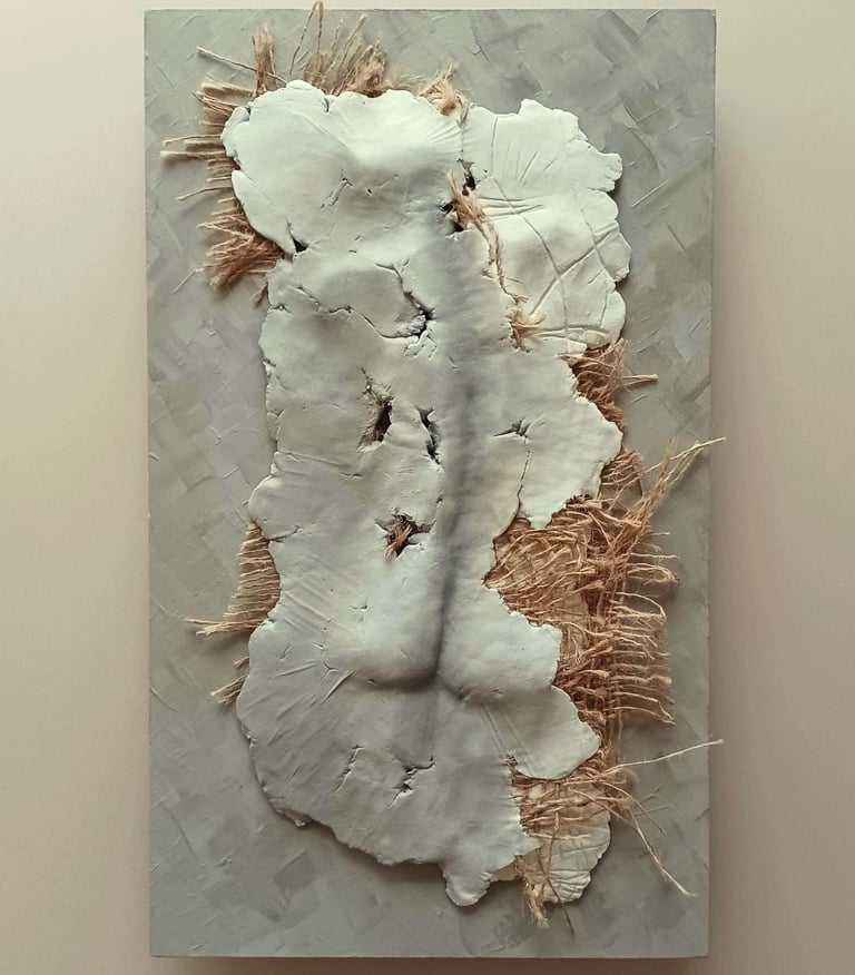 A relief sculpture of a fragmented female (rear view) with protruding hessian, painted cool browns