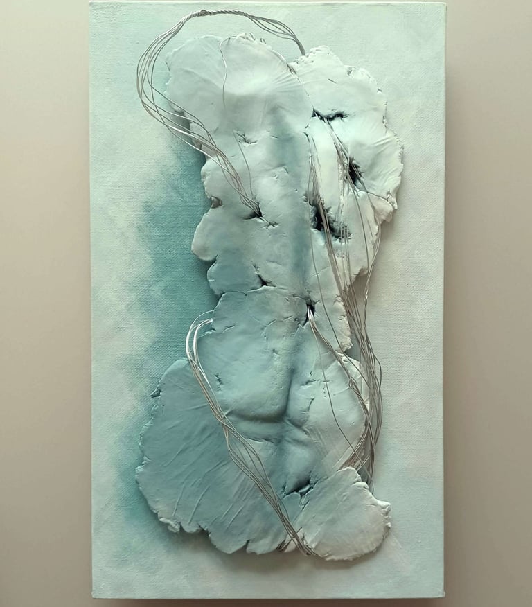 A relief sculpture of a fragmented female (rear view) entwined with wires, painted grey-blues