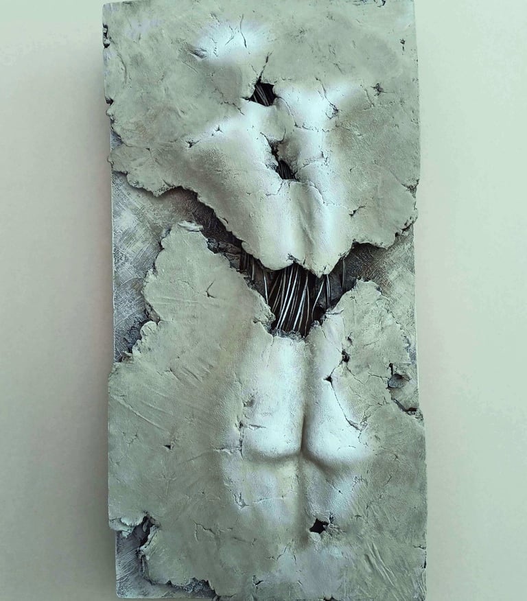A relief sculpture of a fragmented female (rear view) showing exposed wires, painted cool browns