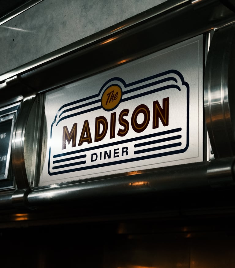 Sign displaying 'Madison Diner' captured by a commercial video production company