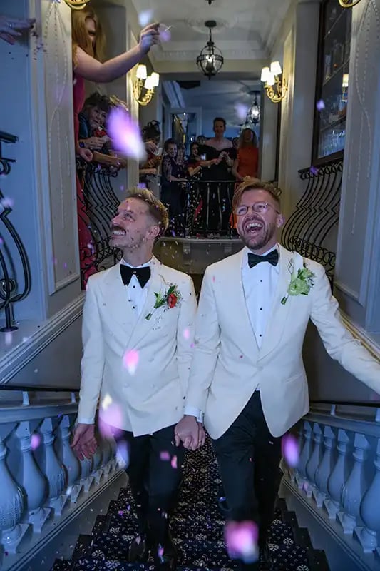 newly-weds enjoying their congetti moment on the stairs in The Trafalgar Tavern Greenwich
