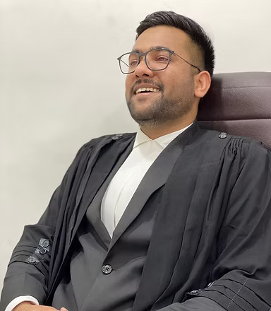 a man in a suit and tie is sitting in a chair