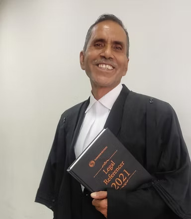 a man in a suit and tie is holding a book