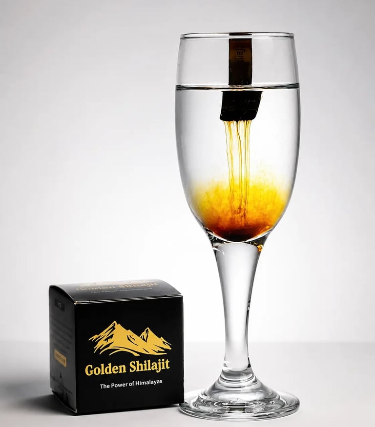 Golden Shilajit resin dissolving in a glass of water next to its black and gold branded packaging.