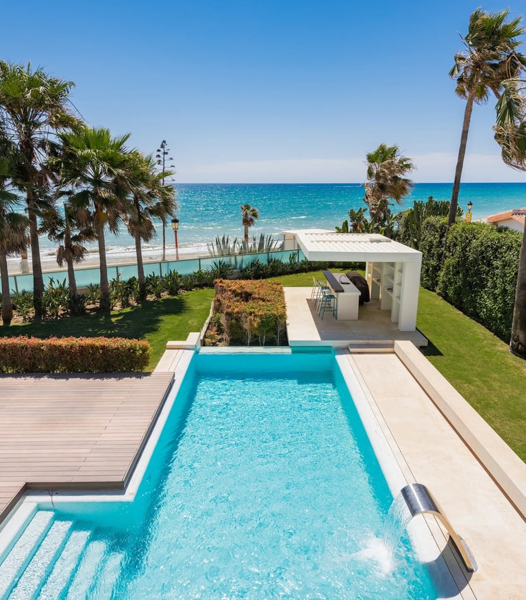 Beachfront pool and garden with outdoor bar pavilion