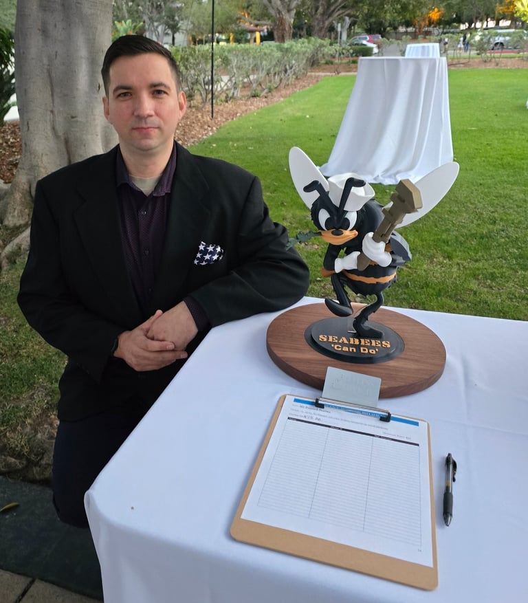 Our founder, next to a donated statue up for auction, with proceeds going to the annual Seabee Ball