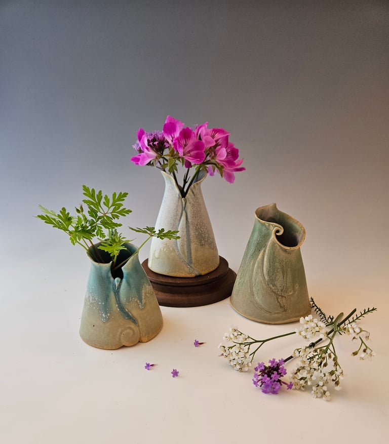 Posy Vases 3 to 4 in. high. Porcelain with microcrystalline glaze. Handbuilt. Highfired ^10.