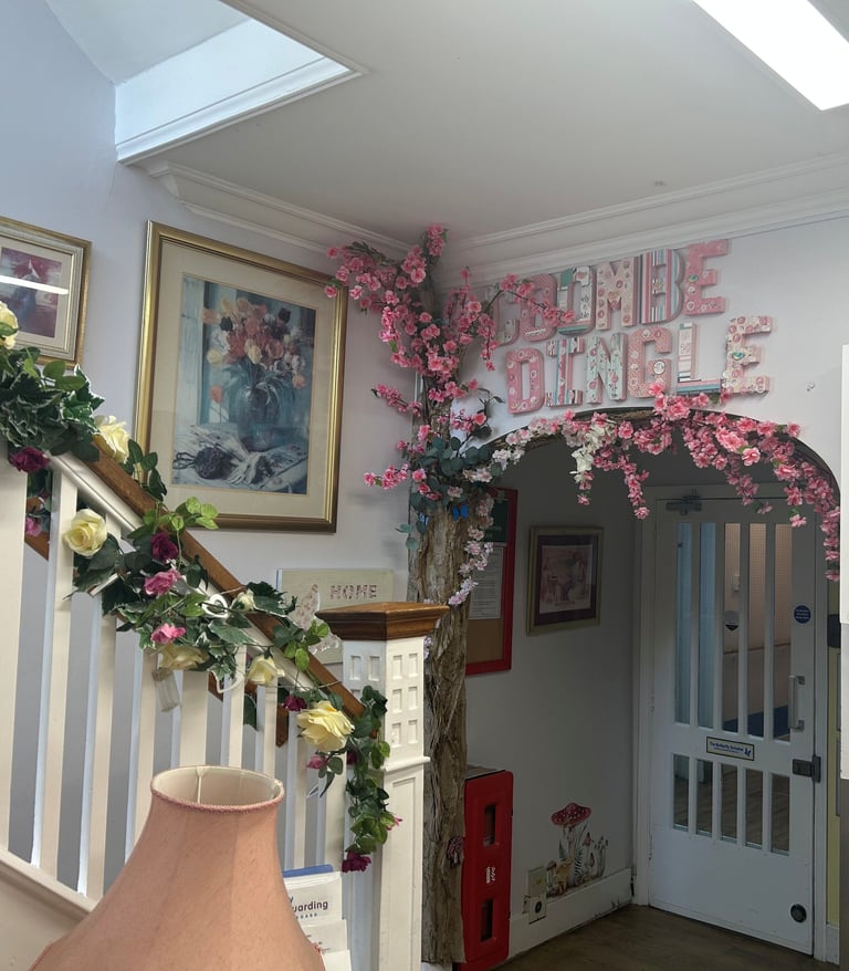 bright entrance hall with flowers along the stairs