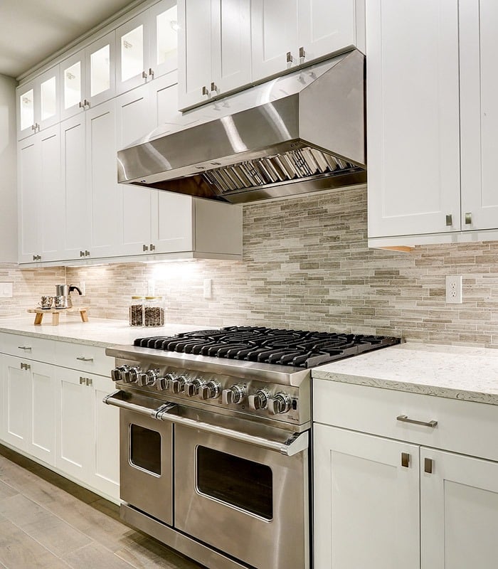 a kitchen with a stove top oven and a range hood