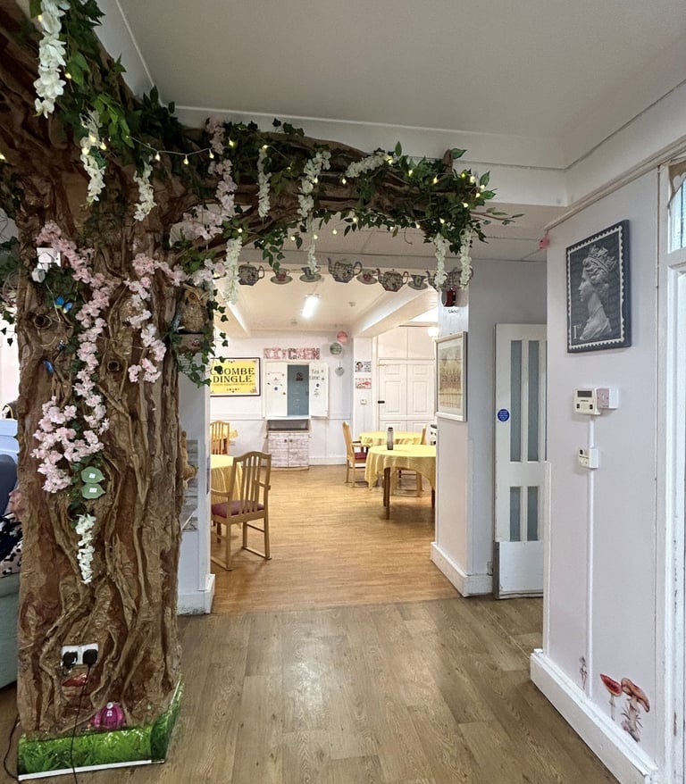 open lounge and dining area with a feature tree decorating the space