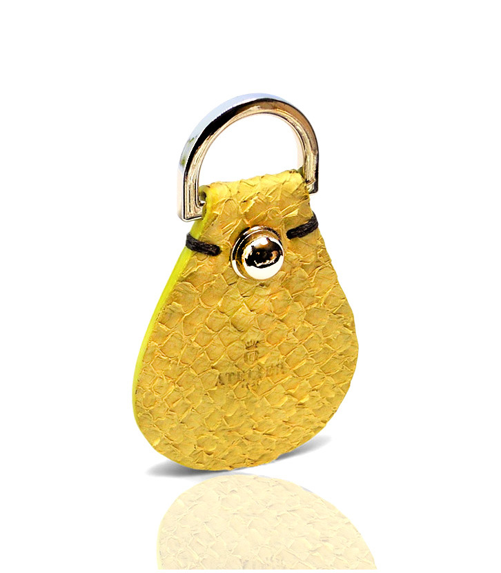 Handmade yellow exotic leather key fob with silver hardware .