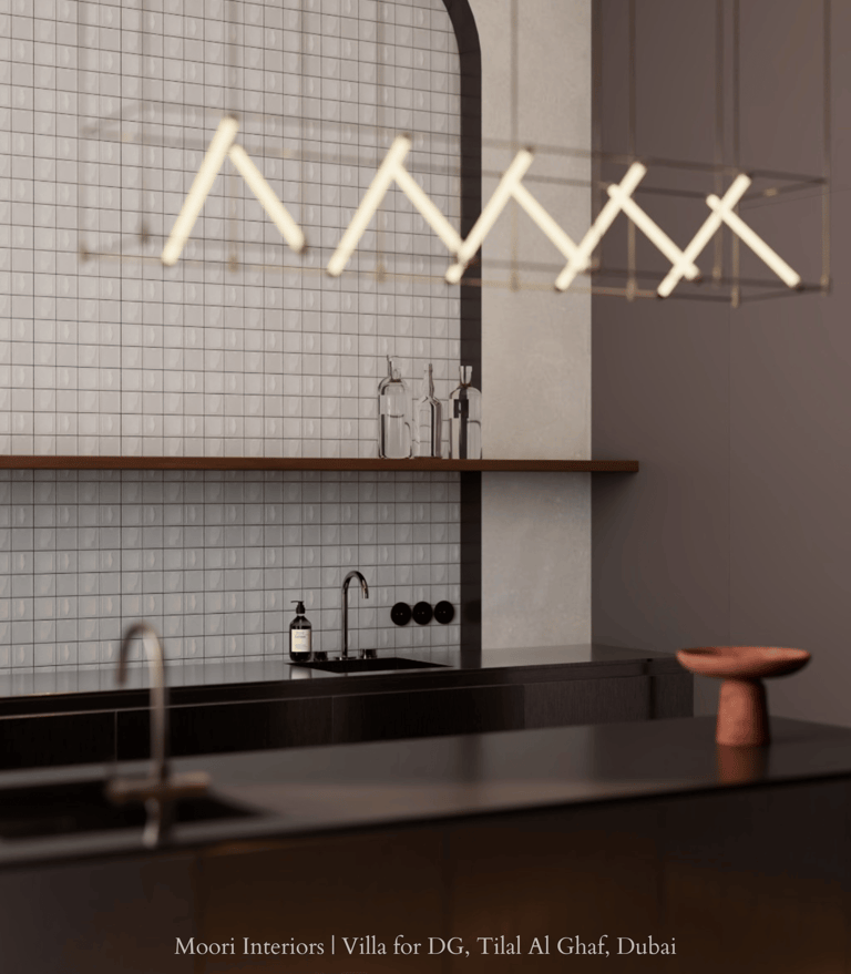 Contemporary kitchen design featuring a dark countertop and illuminated by a linear light fixture.