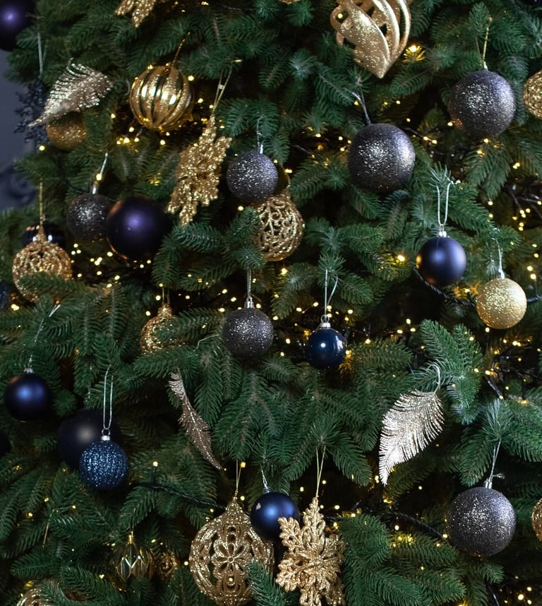 a christmas tree with presents and presents on a wooden floor
