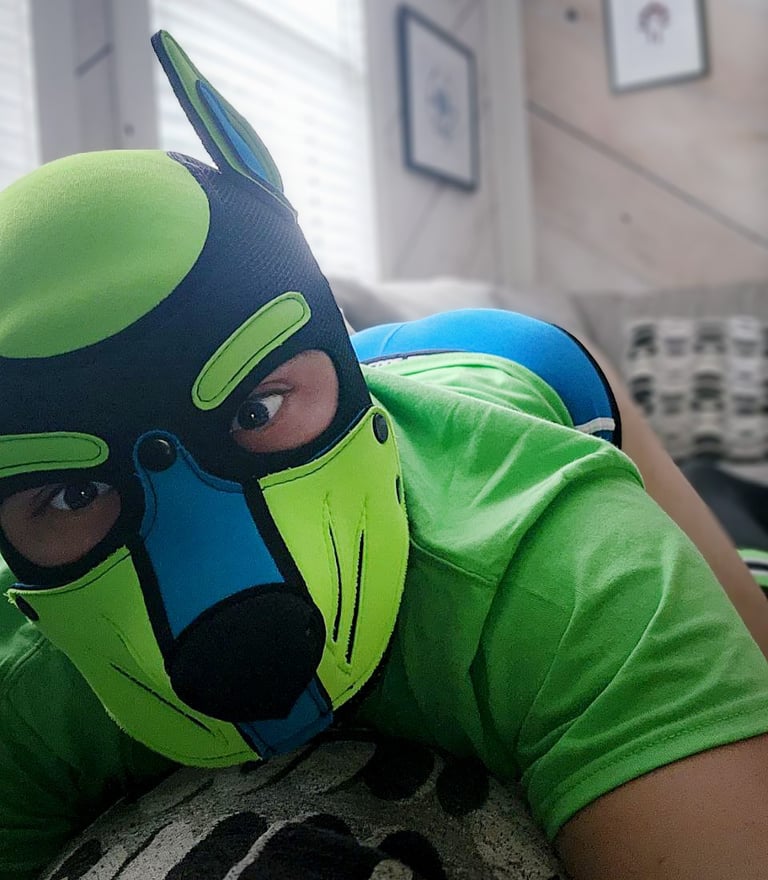 A man posing in his pup mask.