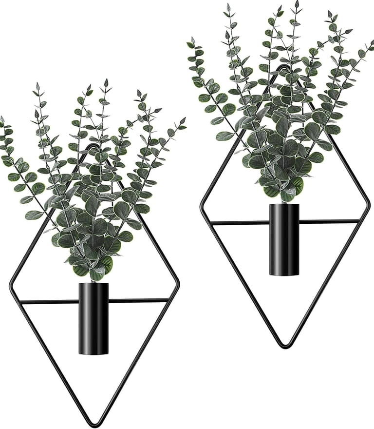 Set of two wall-mounted black diamond geometric planters with artificial eucalyptus greenery for modern home decor.