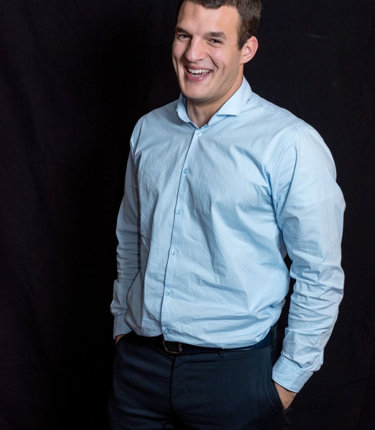 a man in a blue shirt and black pants