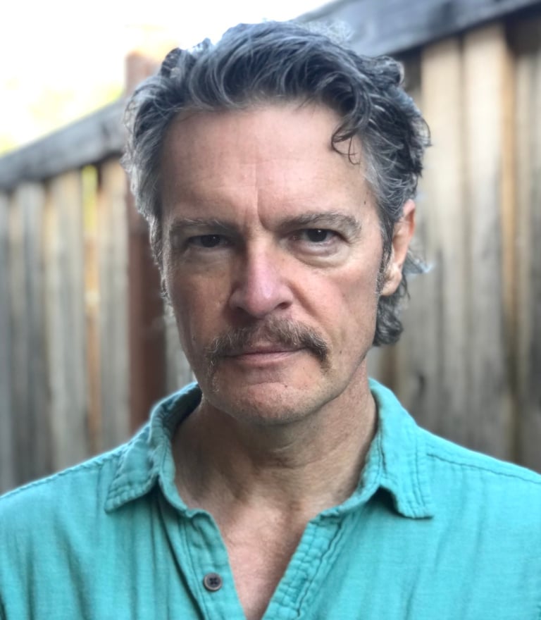 Headshot image of Todd Long with moustache
