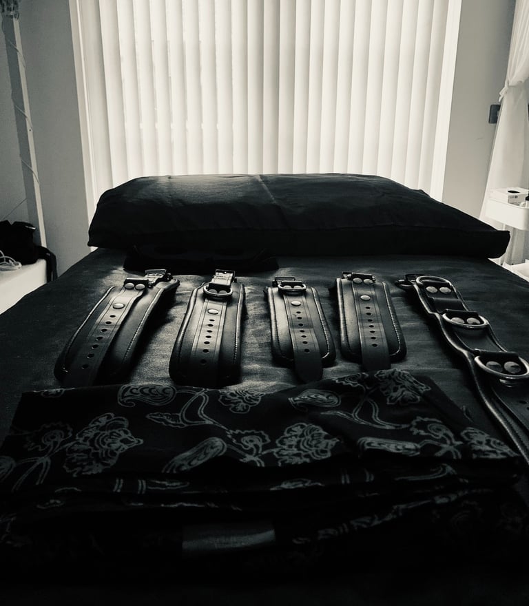 Teal Revel's BDSM massage table with leather cuffs 