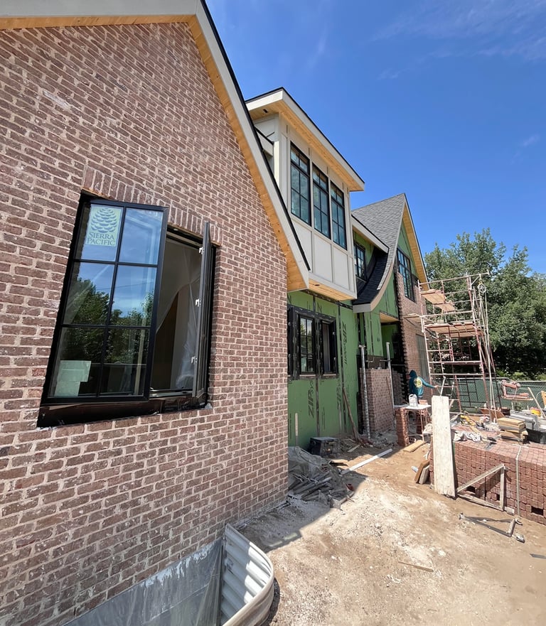a brick building with a green door and a window