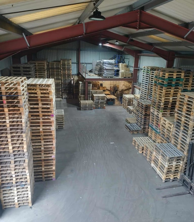 Warehouse with repaired pallets stacked up