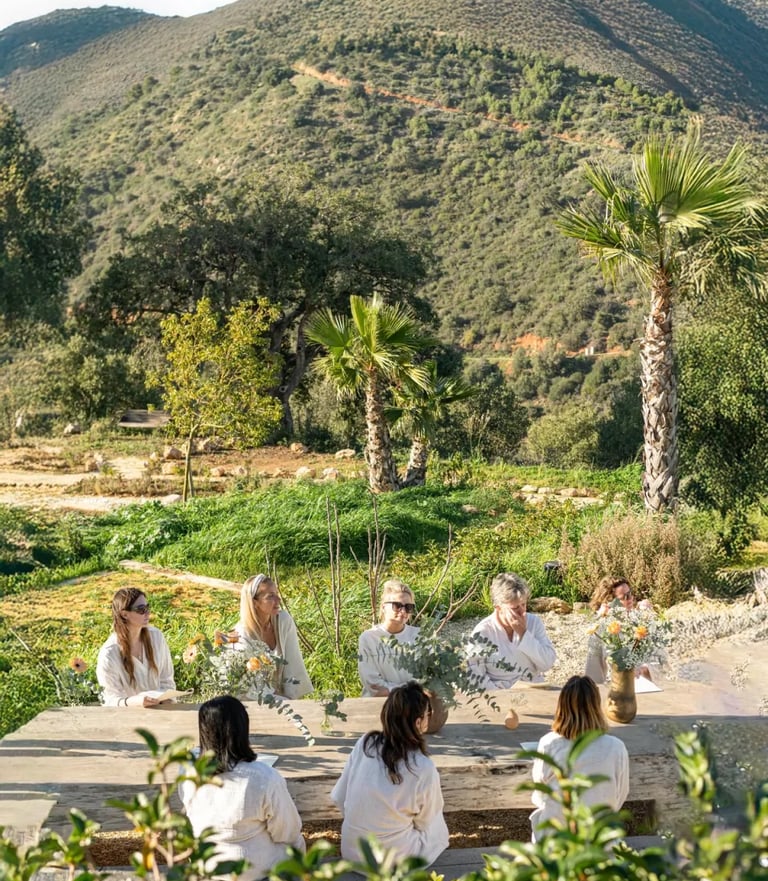 Outdoor group gathering with mountain views and gardens
