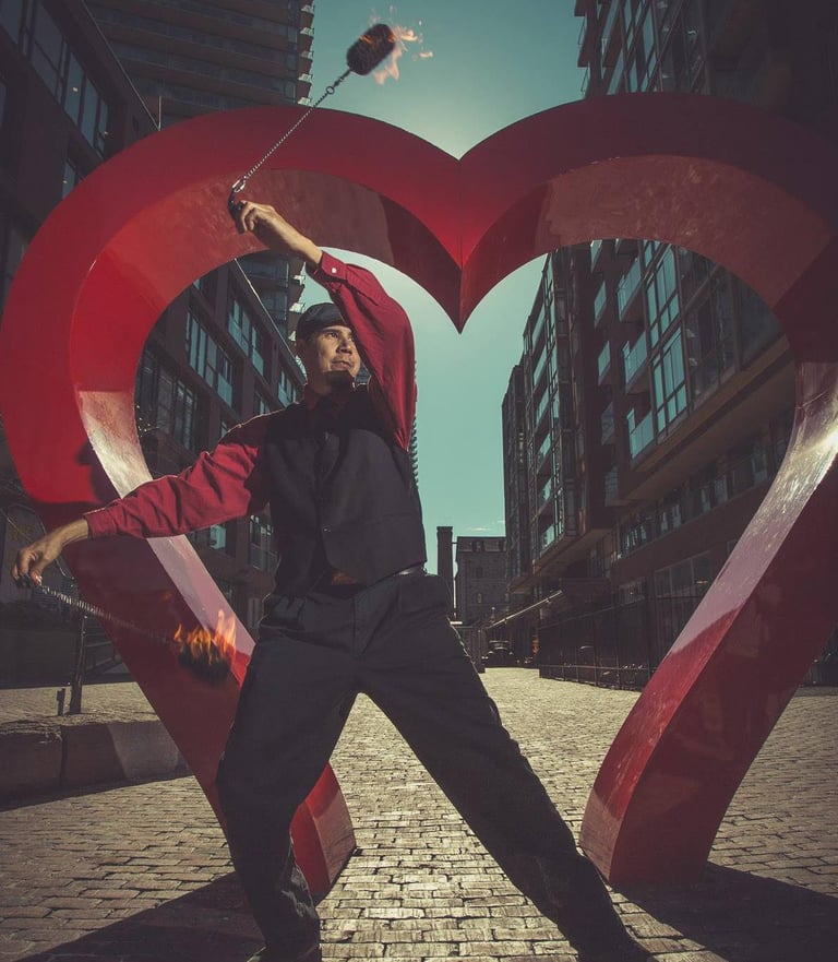 Fire poi dancer in front of heart