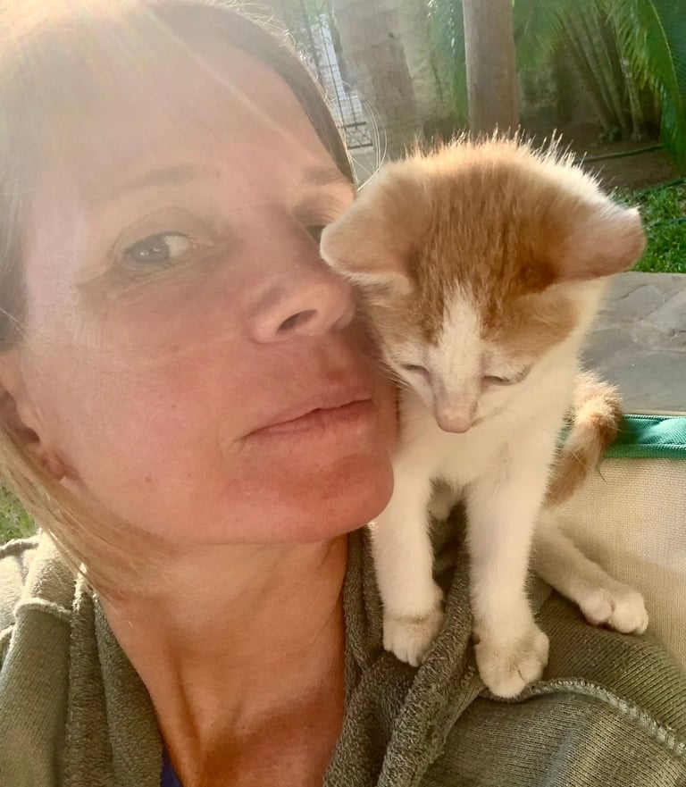 Fran is holding a kitten on her lap