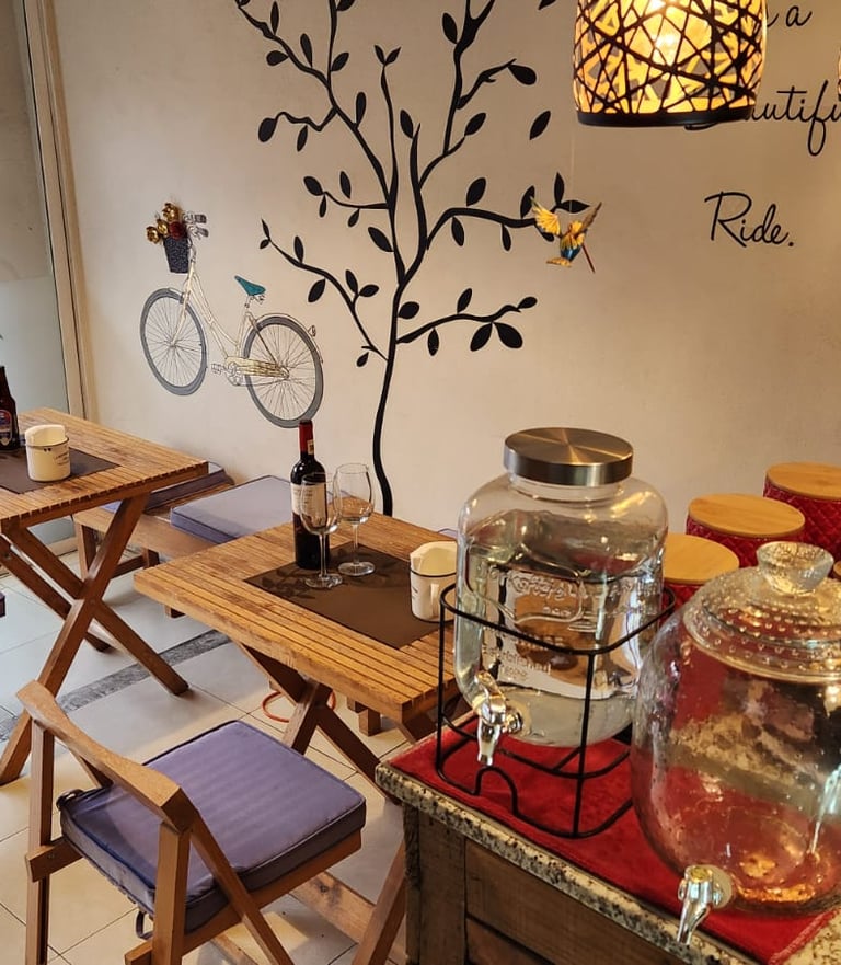 a cafeteria with a table with a wine bottle and a glass of wine
