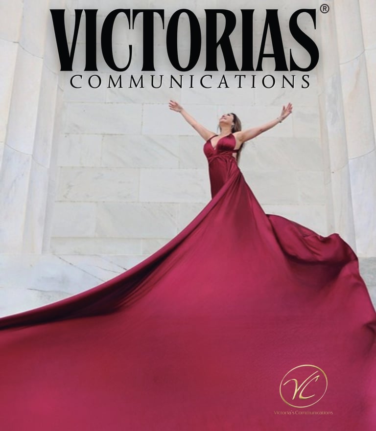Woman in a flowing red gown posing for Victorias Communications against a white marble background.