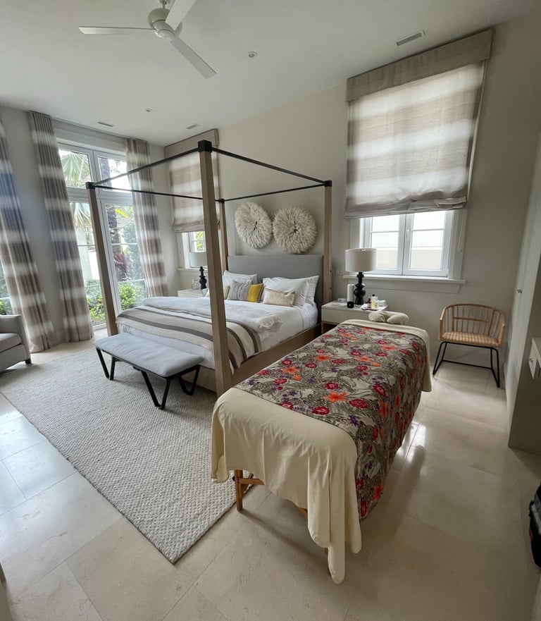a bedroom with a canopy bed and a massages by sophia massage bed