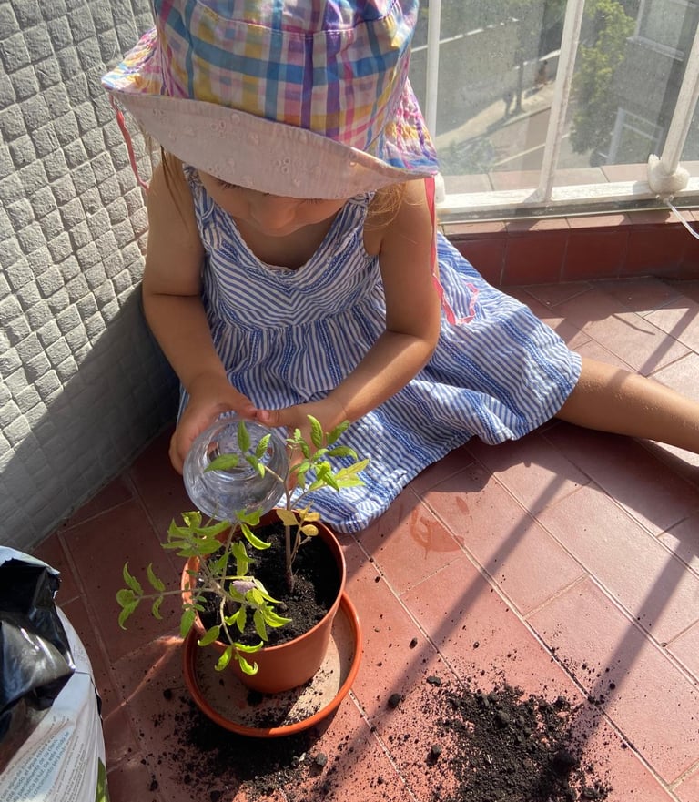criança e bebé a regar as plantas