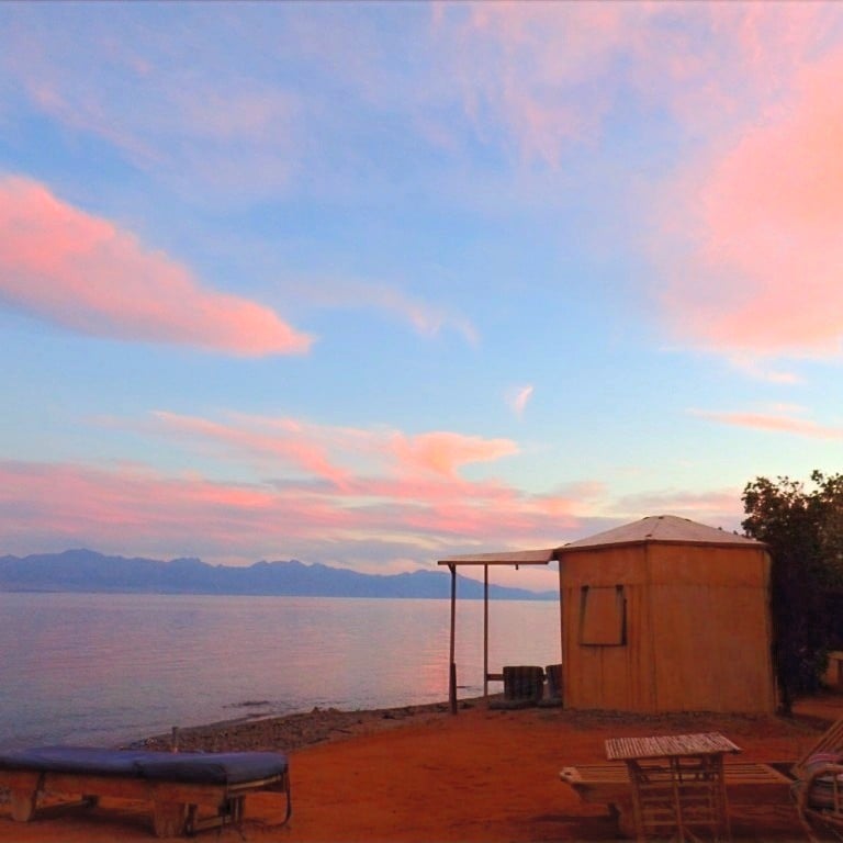 bedouin-star-ras-shetan sunset view over a bungalow and sea