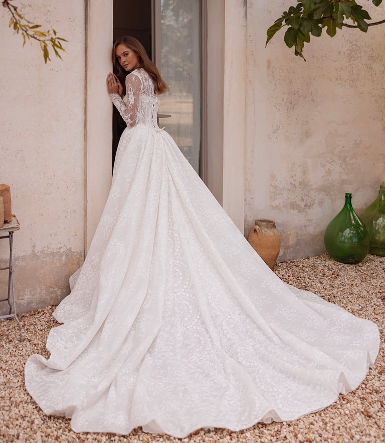 a woman in a wedding dress standing in front of a door