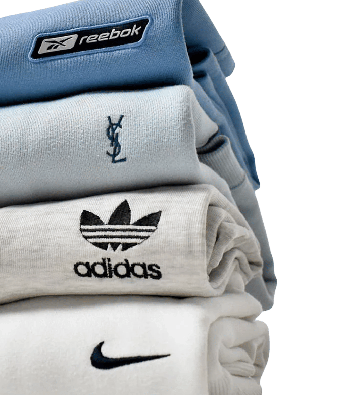 a stack of different branded vintage clothes