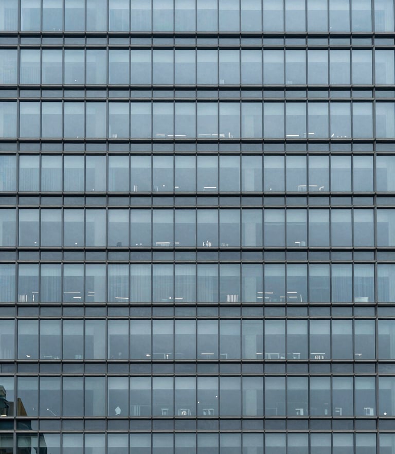 Minimalist architectural detail of a modern steel and glass skyscraper facade, cool overcast daylight, desaturated blue and slate tones, sharp focus