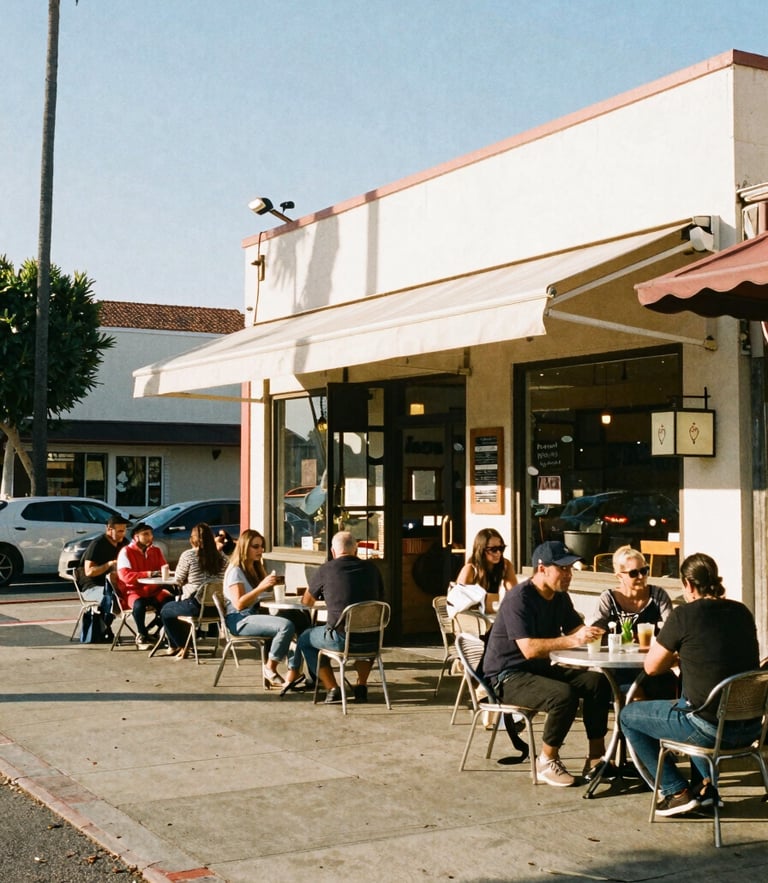 Warm afternoon sun lighting up a busy storefront cafe along Sawtelle Boulevard, local patrons at outdoor tables, 35mm film look.