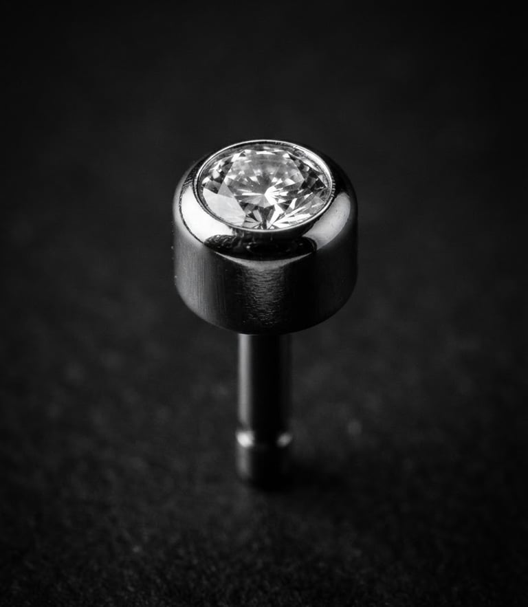 Extreme macro photography of a polished titanium threadless end, high-contrast black and white, sharp directional studio light, deep reflections, floating 3D depth, 85mm