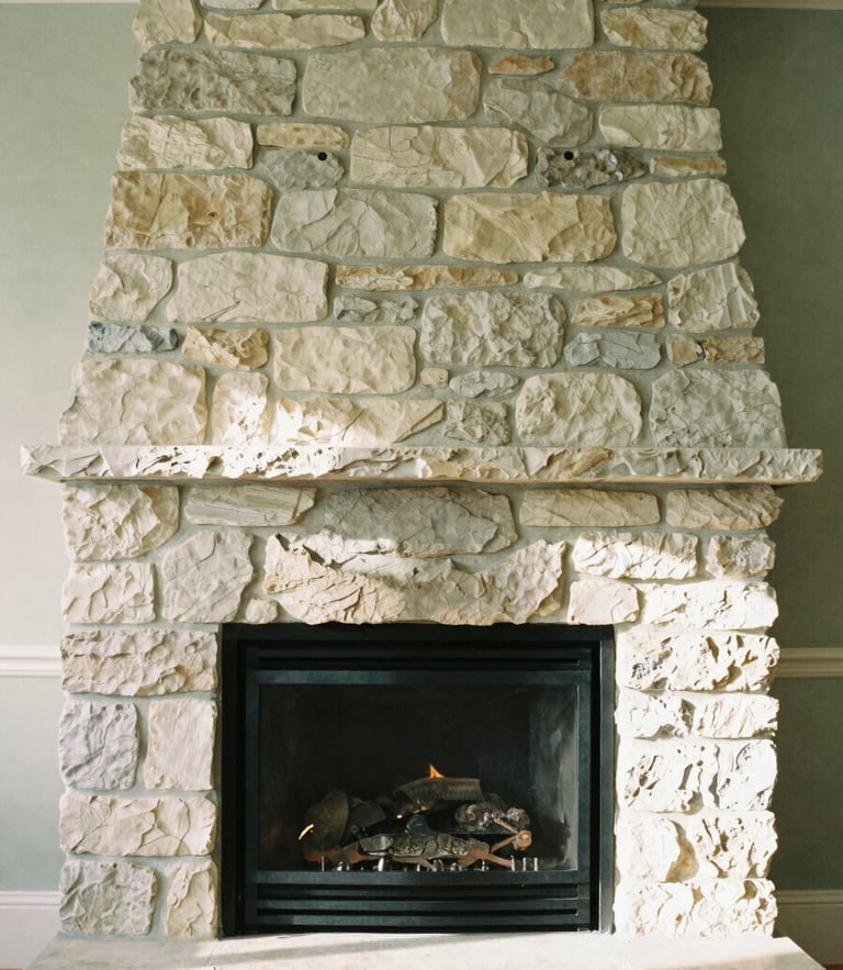 A warm editorial photograph of a sunlit stone fireplace in a Laurentian estate, soft natural daylight, muted forest green and cream tones, shallow depth of field, 35mm.