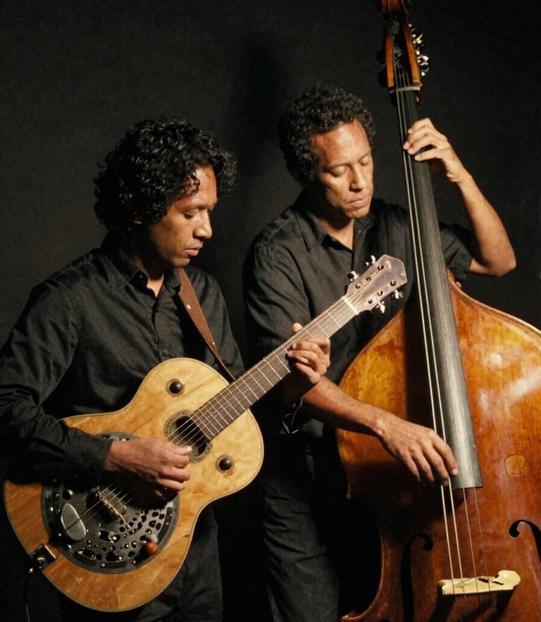 Low-key atmospheric portrait of the blues duo with resonator guitar and upright bass, warm side spotlight, deep charcoal shadows, 35mm film grain.