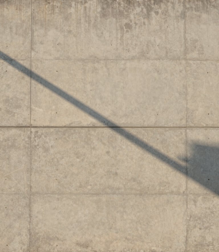 Minimalist architectural detail of a concrete wall in Manhattan Beach under soft morning light, casting clean diagonal shadows, expansive composition.