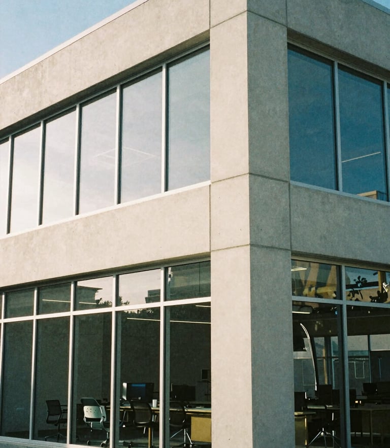 Architectural detail of a modern concrete and glass workspace in Salt Lake City, soft morning daylight, cool shadows, editorial film photography, 35mm lens