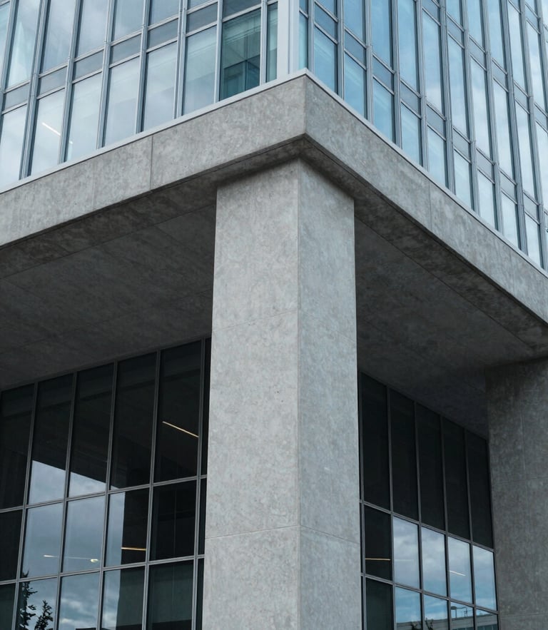 Close-up of a modern architectural concrete column and glass facade of a Canadian corporate headquarters, cool crisp daylight, subtle blue tones, sharp focus, 35mm
