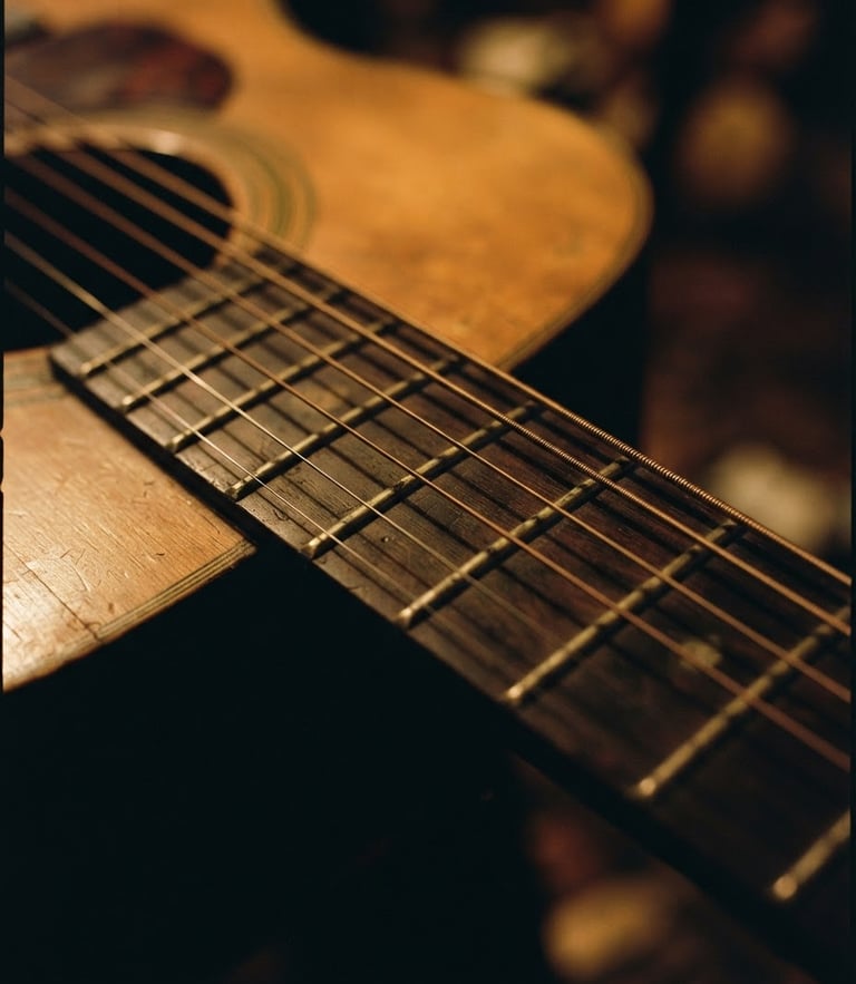 Close-up of vintage acoustic guitar strings, soft dramatic stage lighting, warm golden tones, 35mm film grain