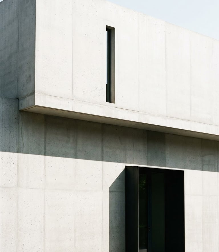 Minimalist architectural photography, bright daylight, clean concrete wall with sharp straight shadows, high-contrast, professional portfolio style, 35mm