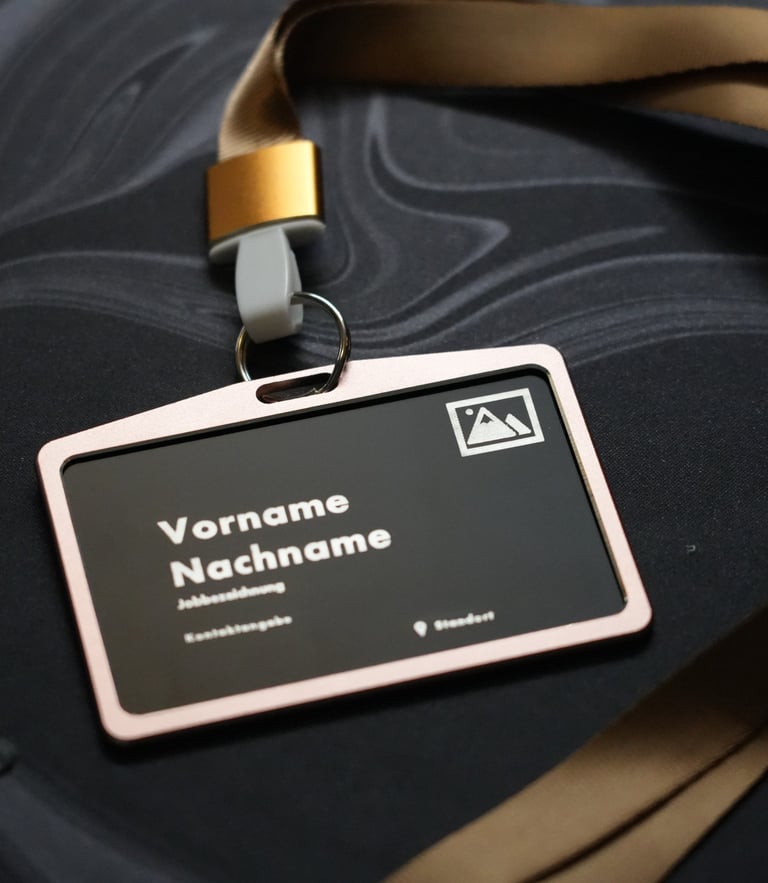 Professional identification badge in a holder with a gold lanyard on a dark marble surface.