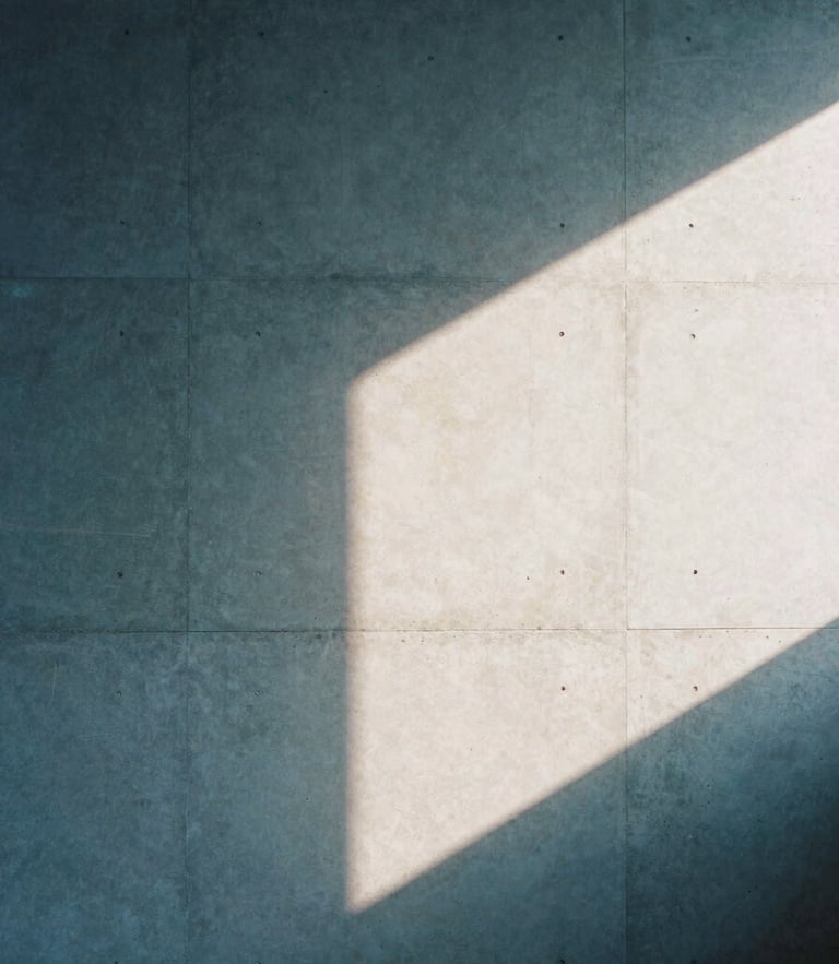 Architectural crop of a minimalist concrete studio wall with soft afternoon window light casting sharp geometric shadows, 35mm