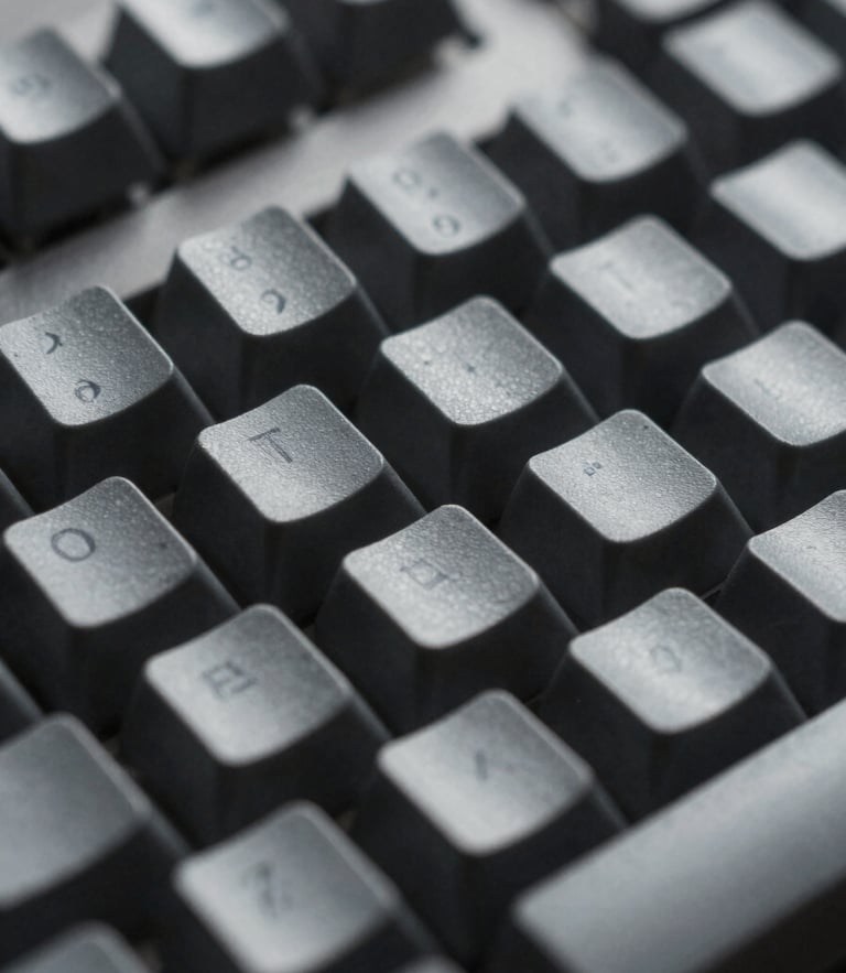 Macro shot of a high-end mechanical keyboard with dark grey keycaps, soft cool diffused studio lighting, shallow depth of field
