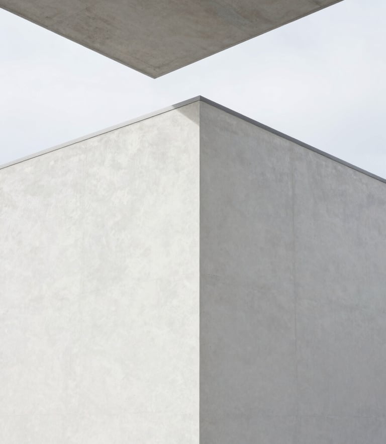Architectural detail of a freshly completed minimalist plaster wall meeting a concrete ceiling under bright overcast Belgian daylight, razor-sharp lines, clean geometric angles, 35mm lens.